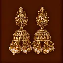 Ornate Gold Jhumka Earrings on Brown.webp